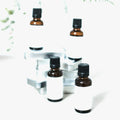Geranium essential oil in amber dropper bottles on a white studio background