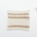 Crocheted cotton tawashi sponge on a white background