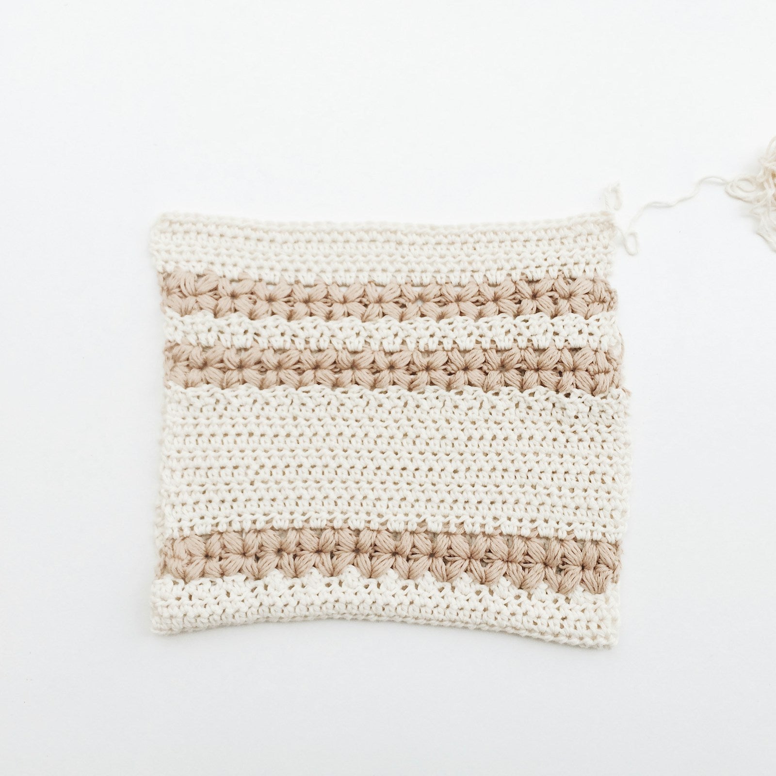 Crocheted cotton tawashi sponge on a white background