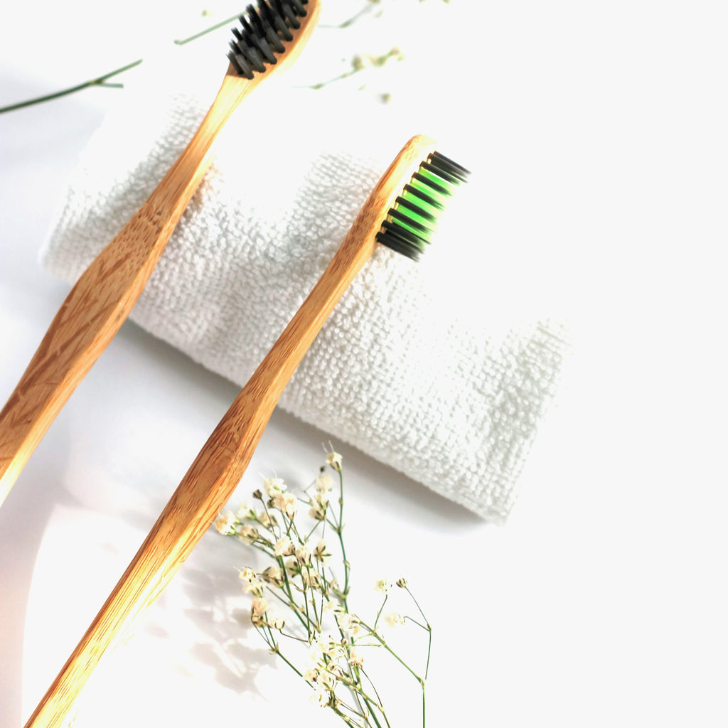 Bamboo toothbrushes with replaceable heads on a white background