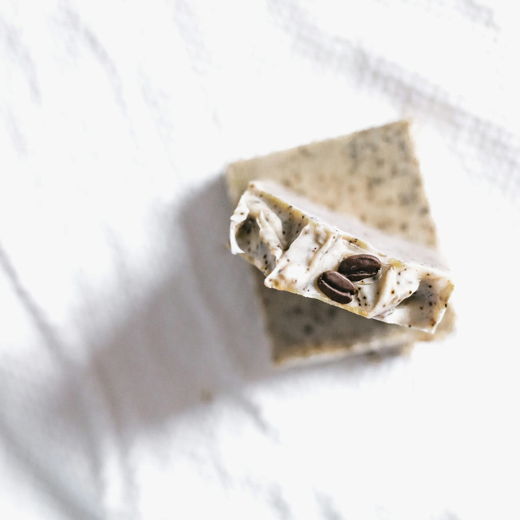 Exfoliating body bar with natural scrub particles on a white studio background