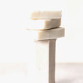 Solid shaving soap bars stacked on white background