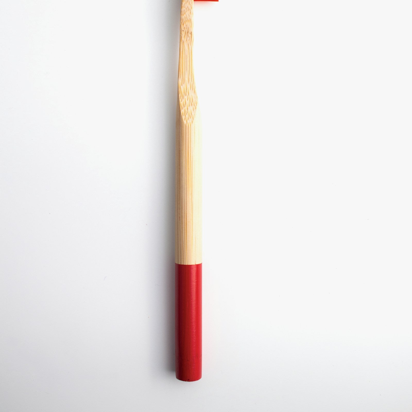 Kids bamboo toothbrush, red handle, white background
