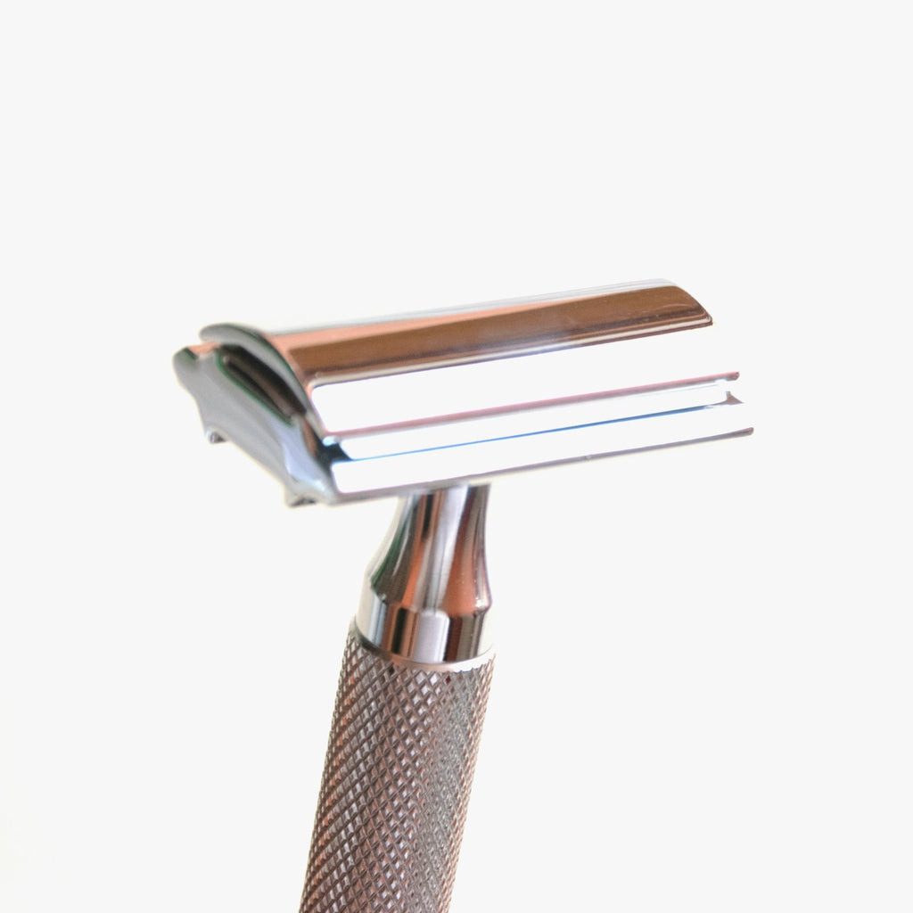 Double edge safety razor head close-up on a white studio background