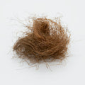 Coconut fibre scrubber on a white background