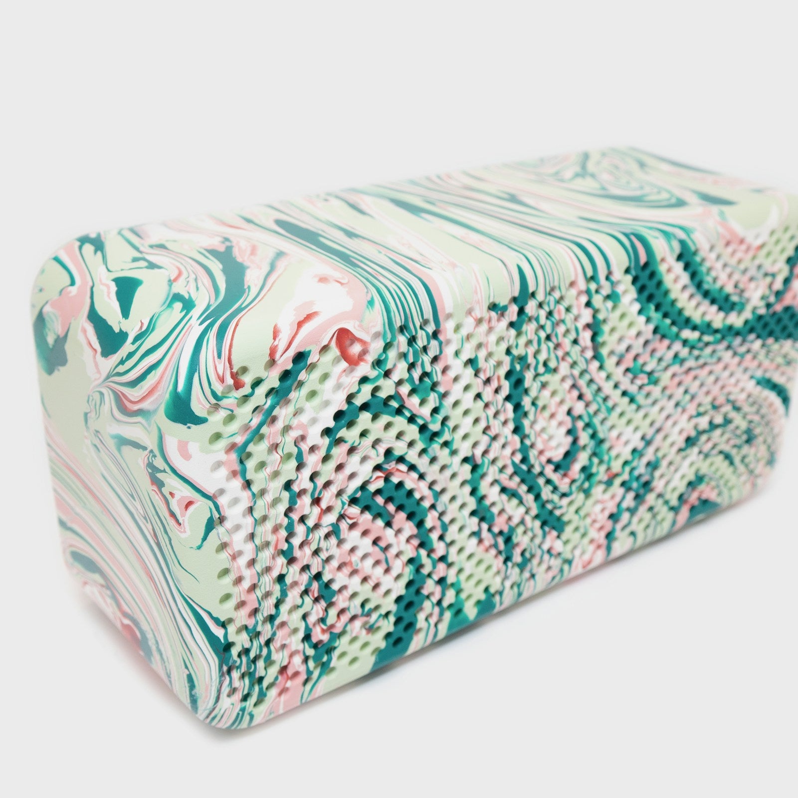 Handmade natural soap bar with marbled swirl pattern on a white background