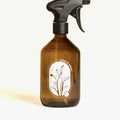 Amber glass spray bottle with trigger nozzle on a white background